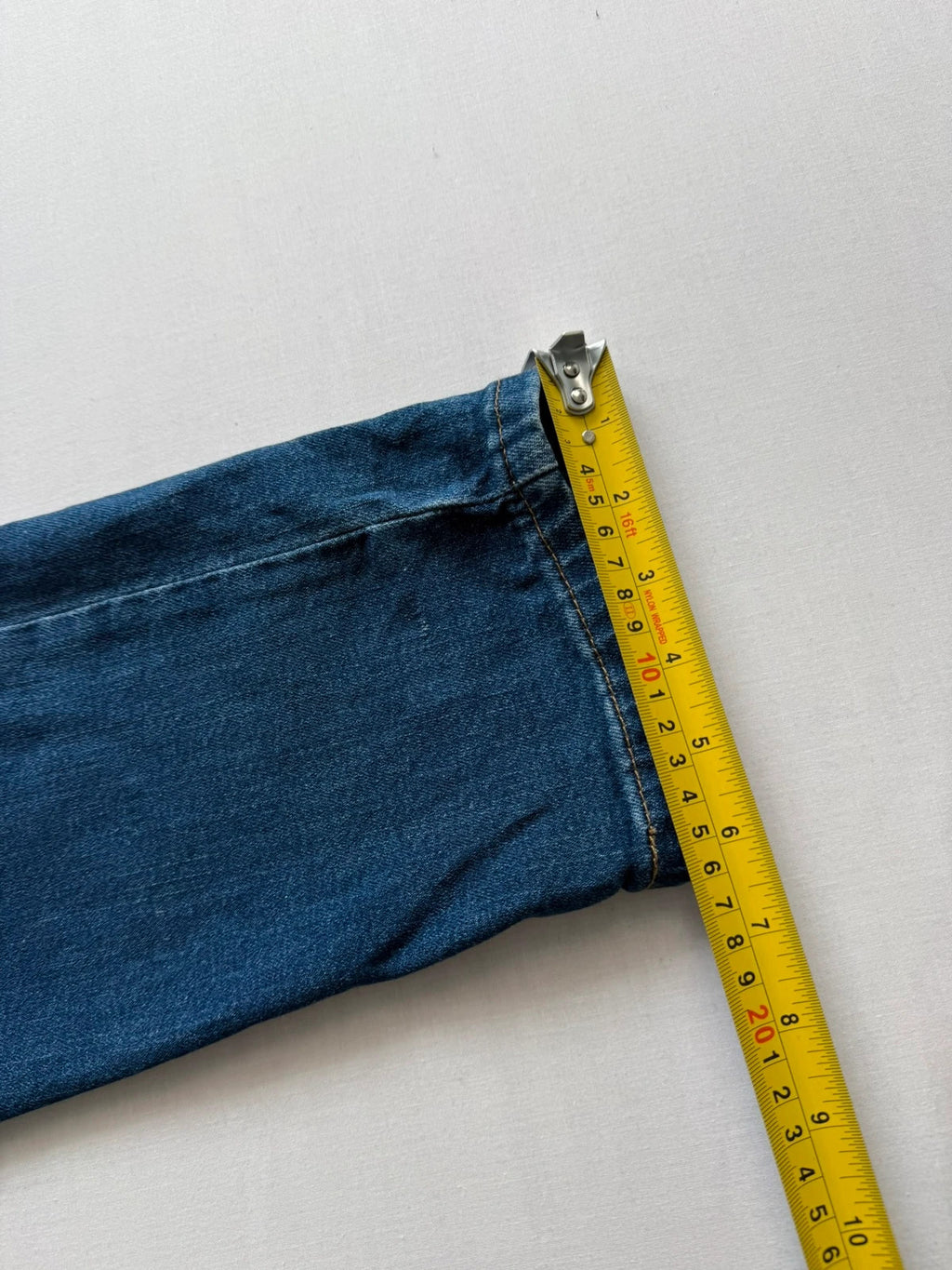 Levi's blue slim tapered jeans with classic five-pocket styling in medium wash.