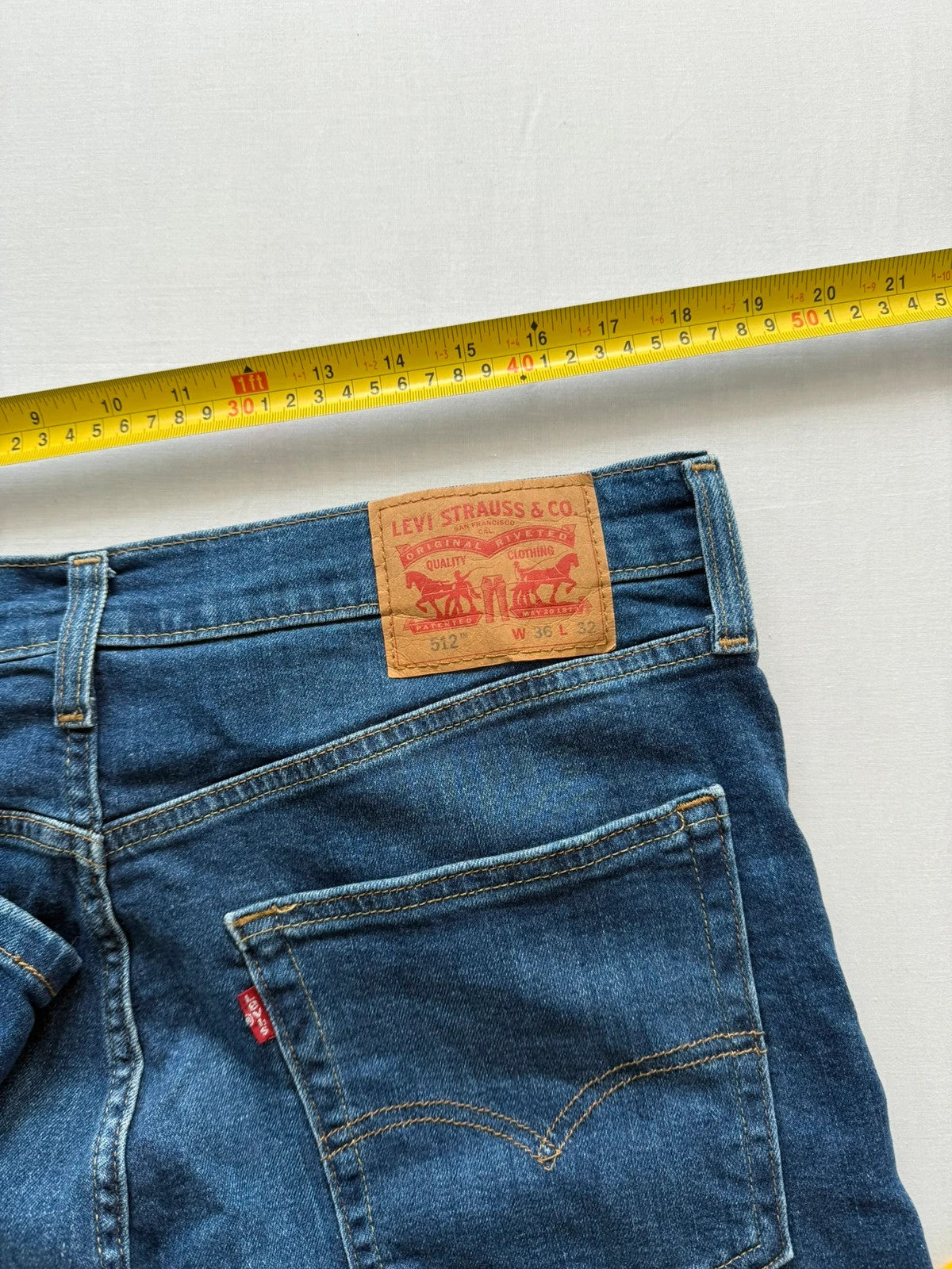 Levi's blue slim tapered jeans with classic five-pocket styling in medium wash.