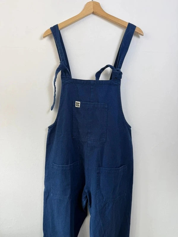 Lucy & Yak navy dungarees with adjustable straps, front bib pocket, and relaxed fit.