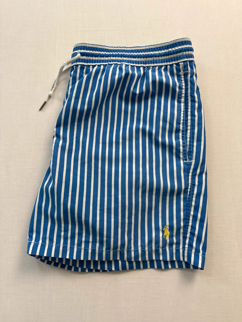 Ralph Lauren blue and white striped swim shorts with classic pony embroidery and drawstring waist.