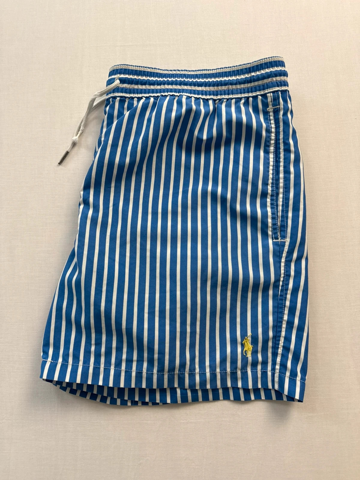 Ralph Lauren blue and white striped swim shorts with classic pony embroidery and drawstring waist.