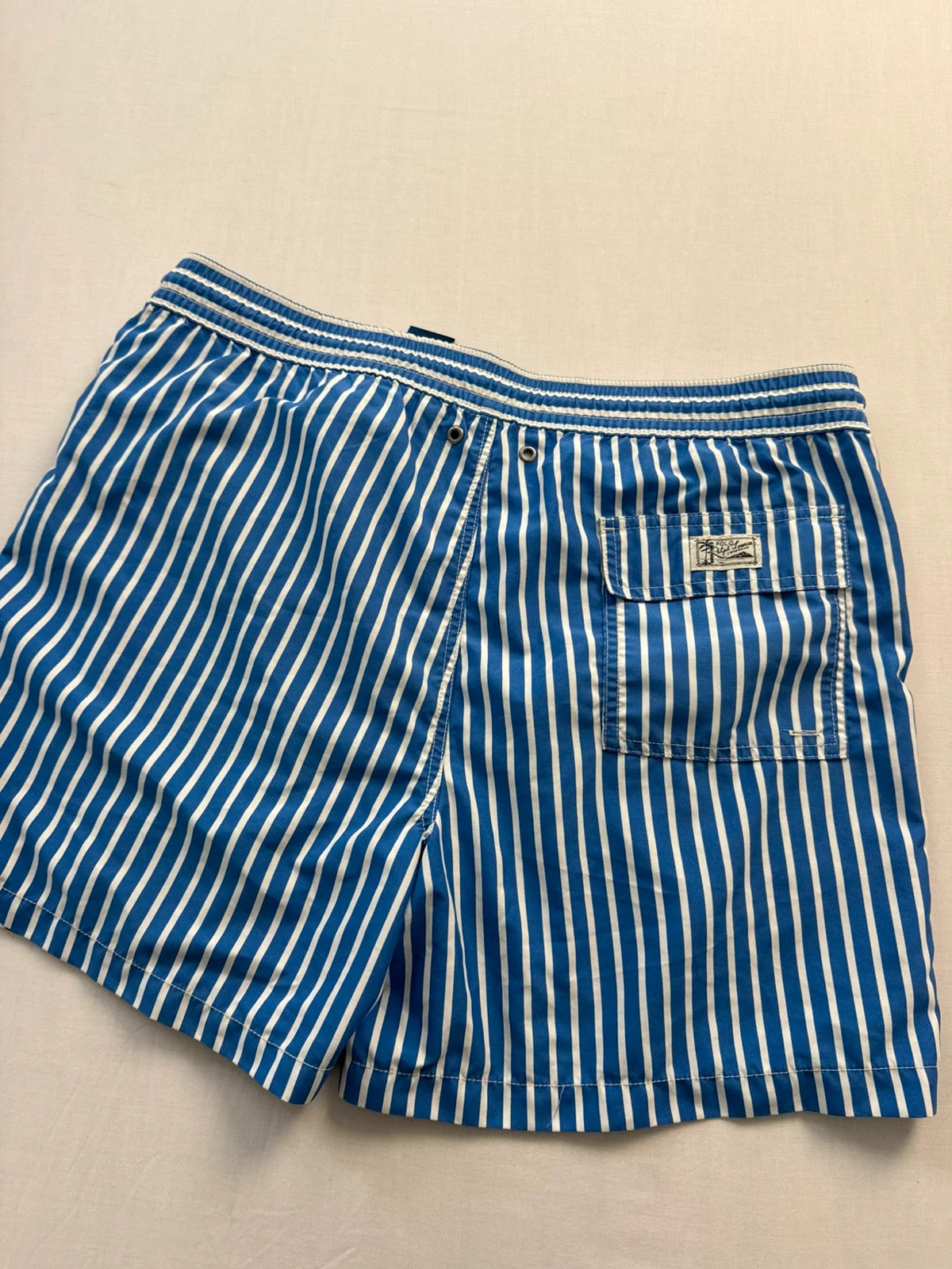 Ralph Lauren blue and white striped swim shorts with classic pony embroidery and drawstring waist.