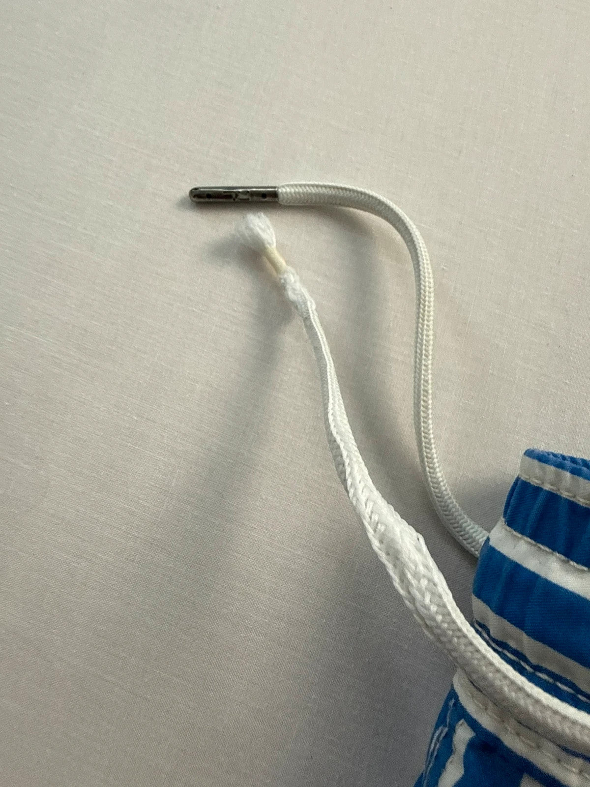 Ralph Lauren blue and white striped swim shorts with classic pony embroidery and drawstring waist.