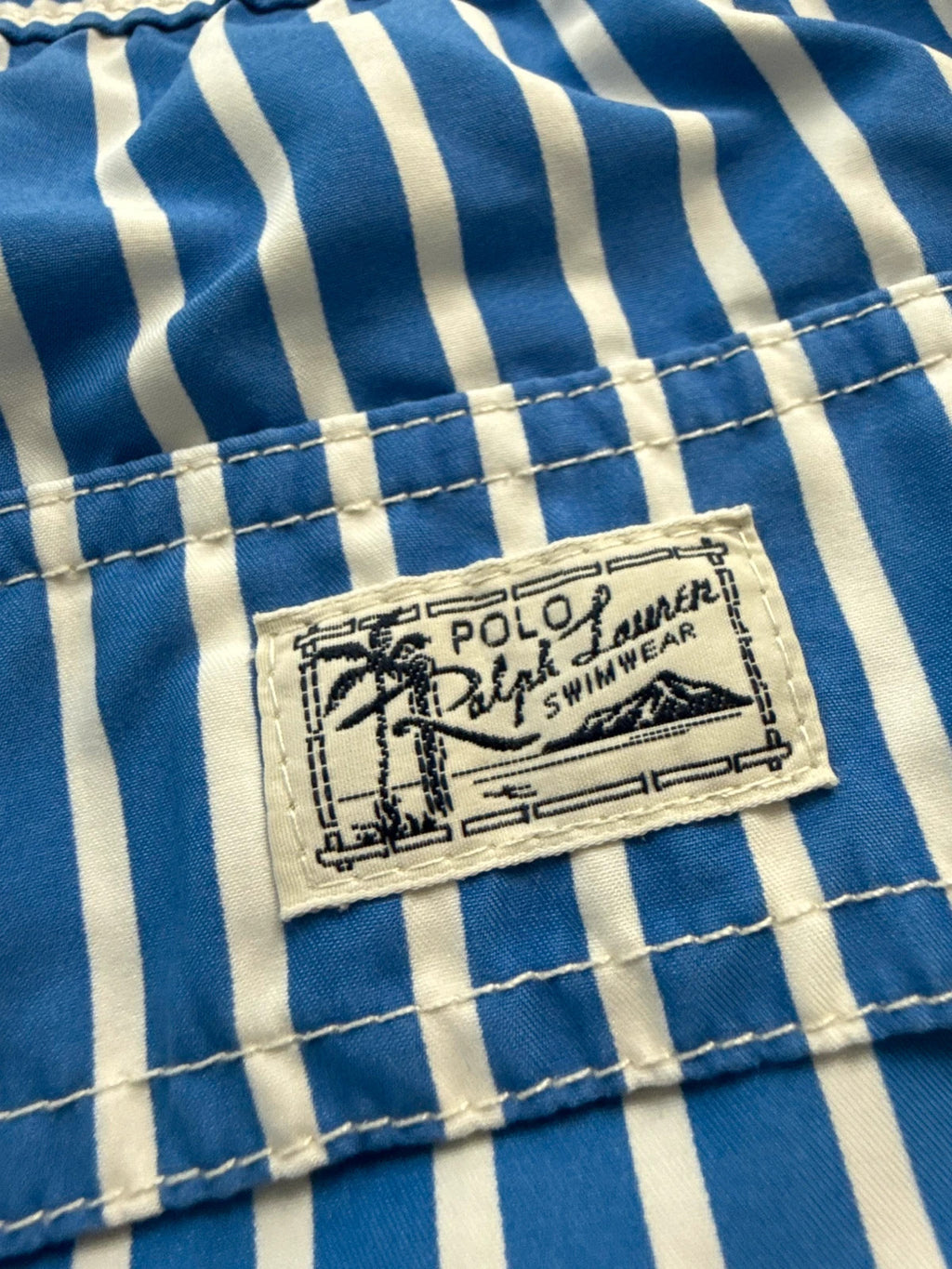 Ralph Lauren blue and white striped swim shorts with classic pony embroidery and drawstring waist.