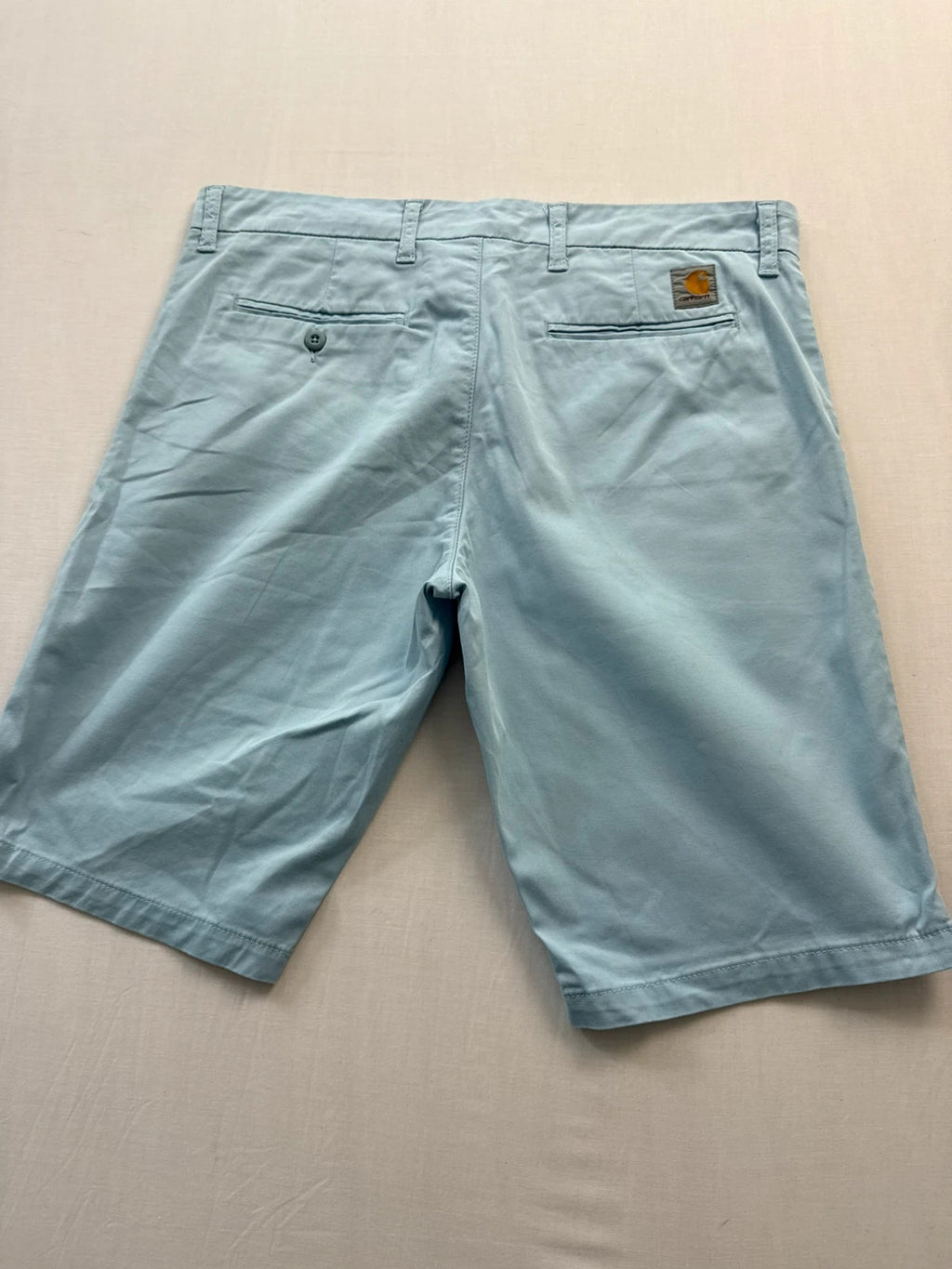 Carhartt light blue chino shorts with back pocket branded patch and soft stretch cotton twill.