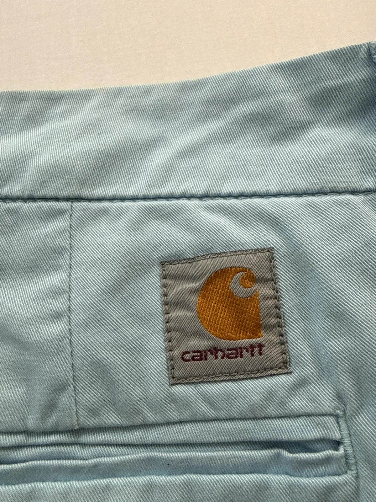 Carhartt light blue chino shorts with back pocket branded patch and soft stretch cotton twill.