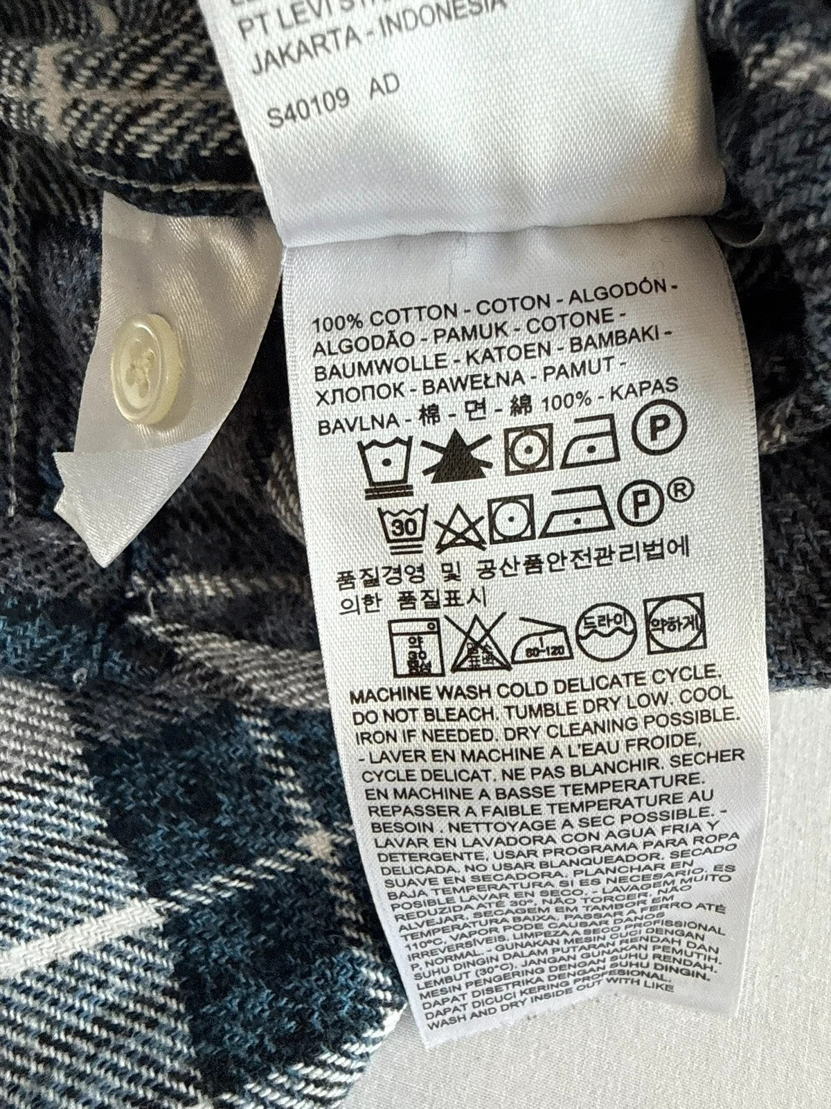 Levi's blue and grey plaid flannel shirt, thick cotton, chest button-flap pockets.