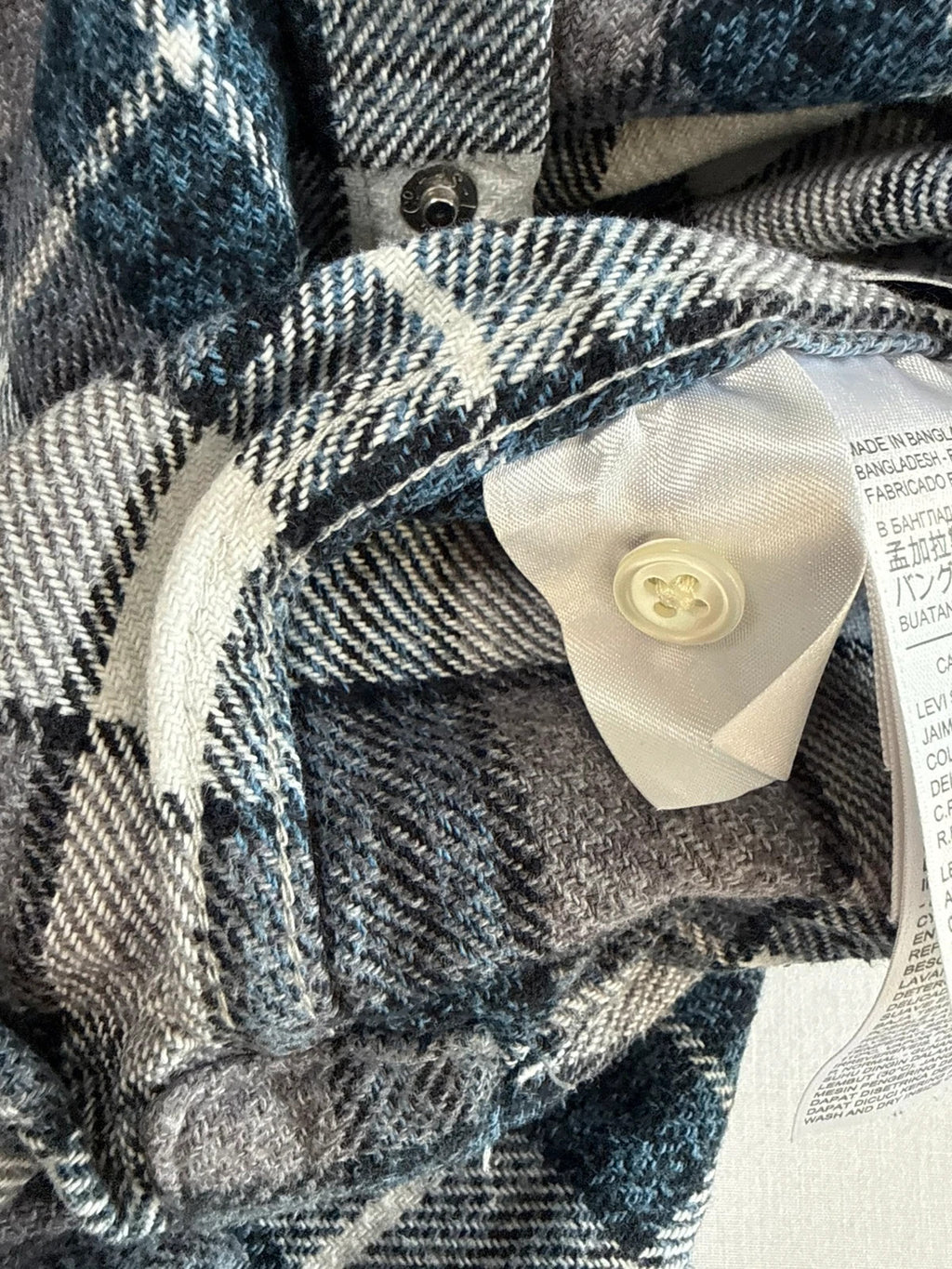 Levi's blue and grey plaid flannel shirt, thick cotton, chest button-flap pockets.