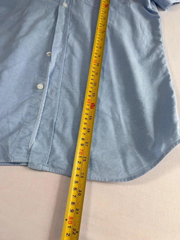 Lacoste light blue short sleeve Oxford shirt with embroidered crocodile logo and button-down collar.