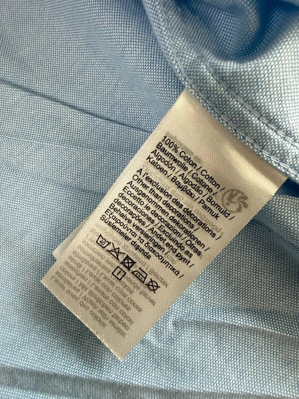 Lacoste light blue short sleeve Oxford shirt with embroidered crocodile logo and button-down collar.