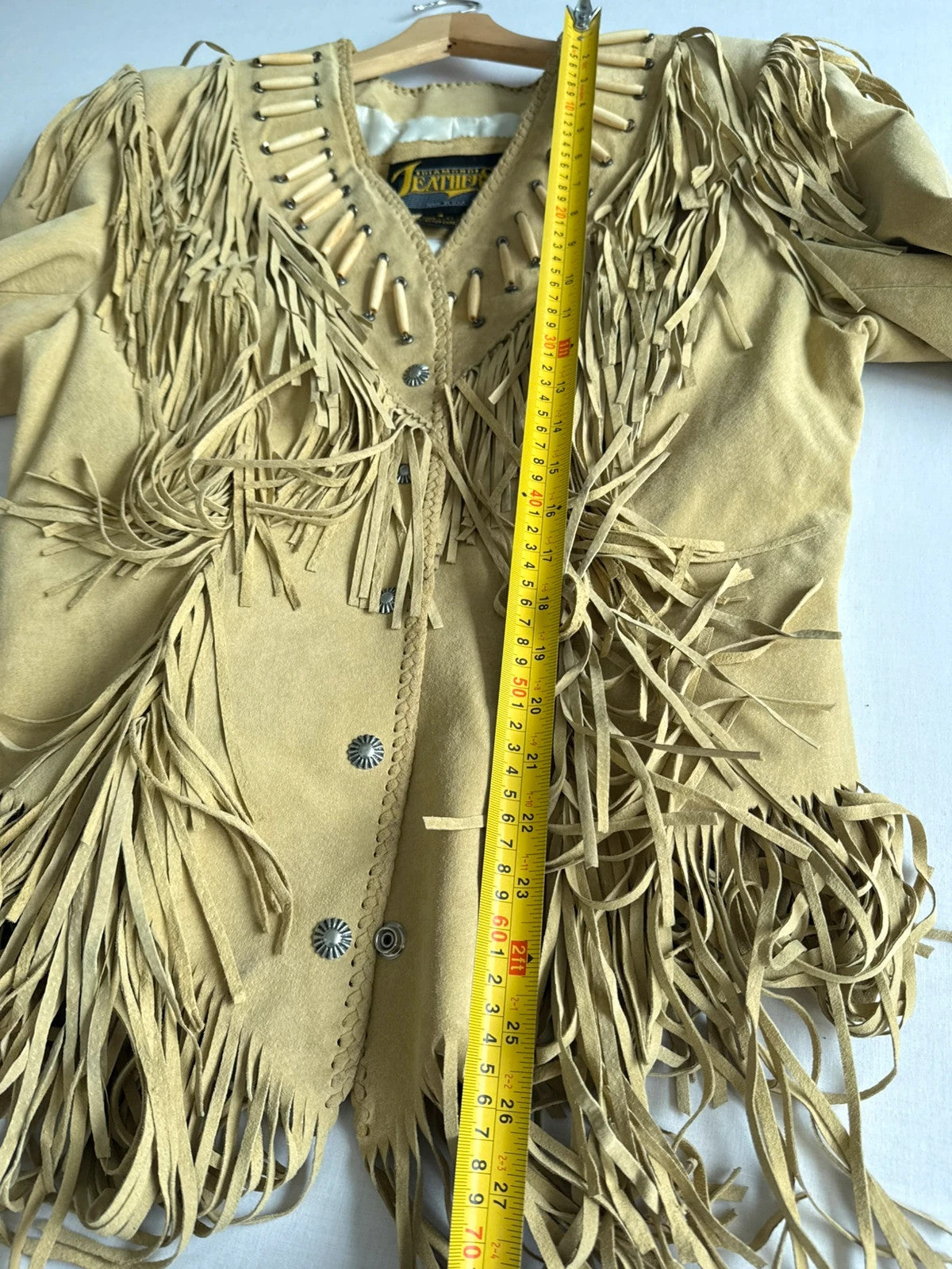 Diamond Leathers tan suede jacket with fringe, beaded arrow detailing, and snap closure.
