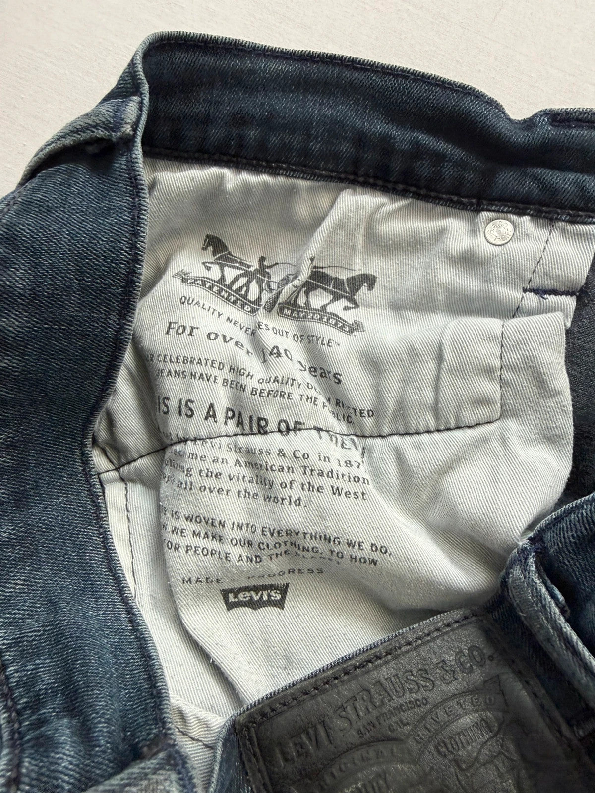 Levi's straight jeans dark indigo black wash with signature back arcuate stitching.