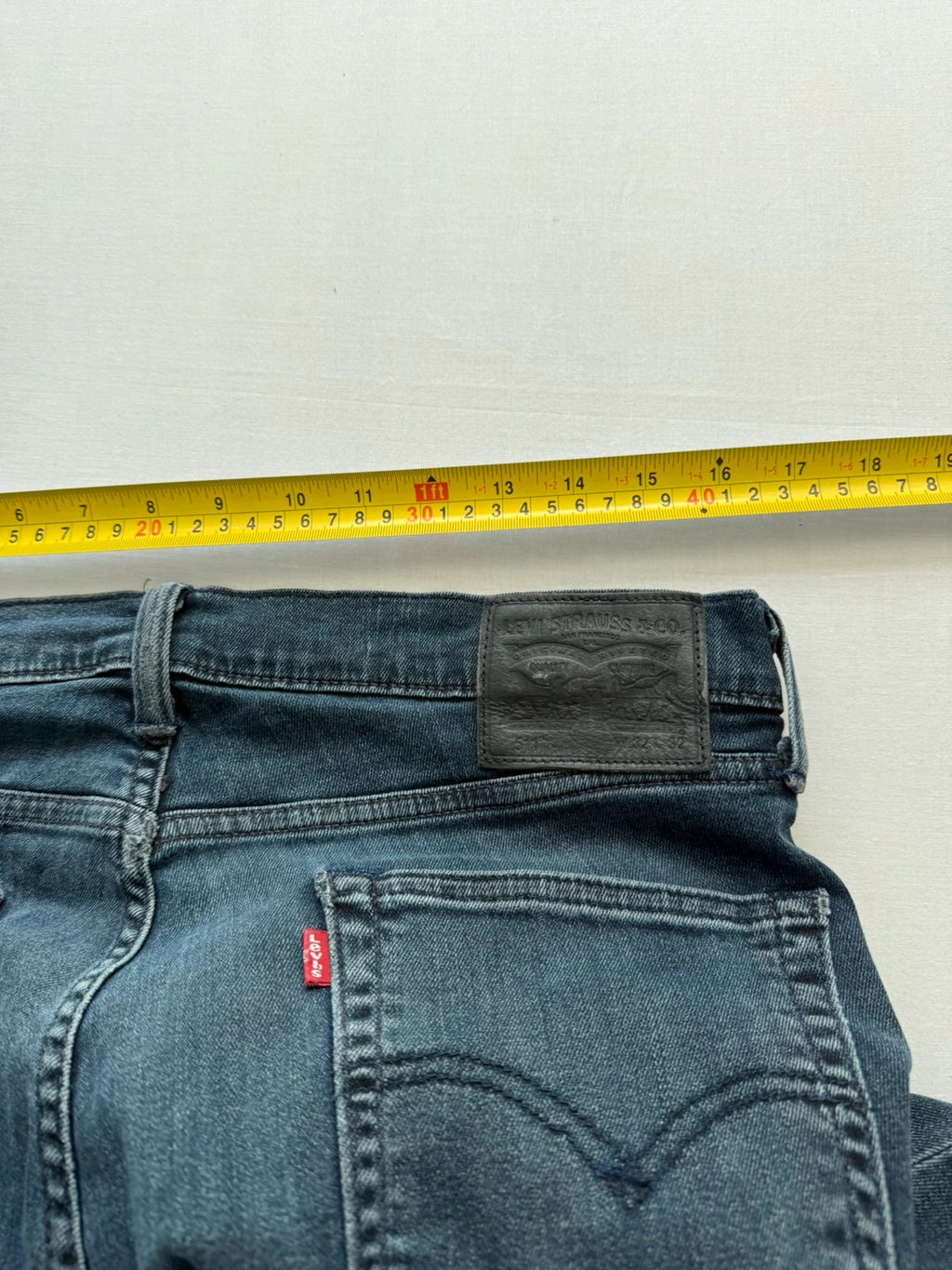 Levi's straight jeans dark indigo black wash with signature back arcuate stitching.
