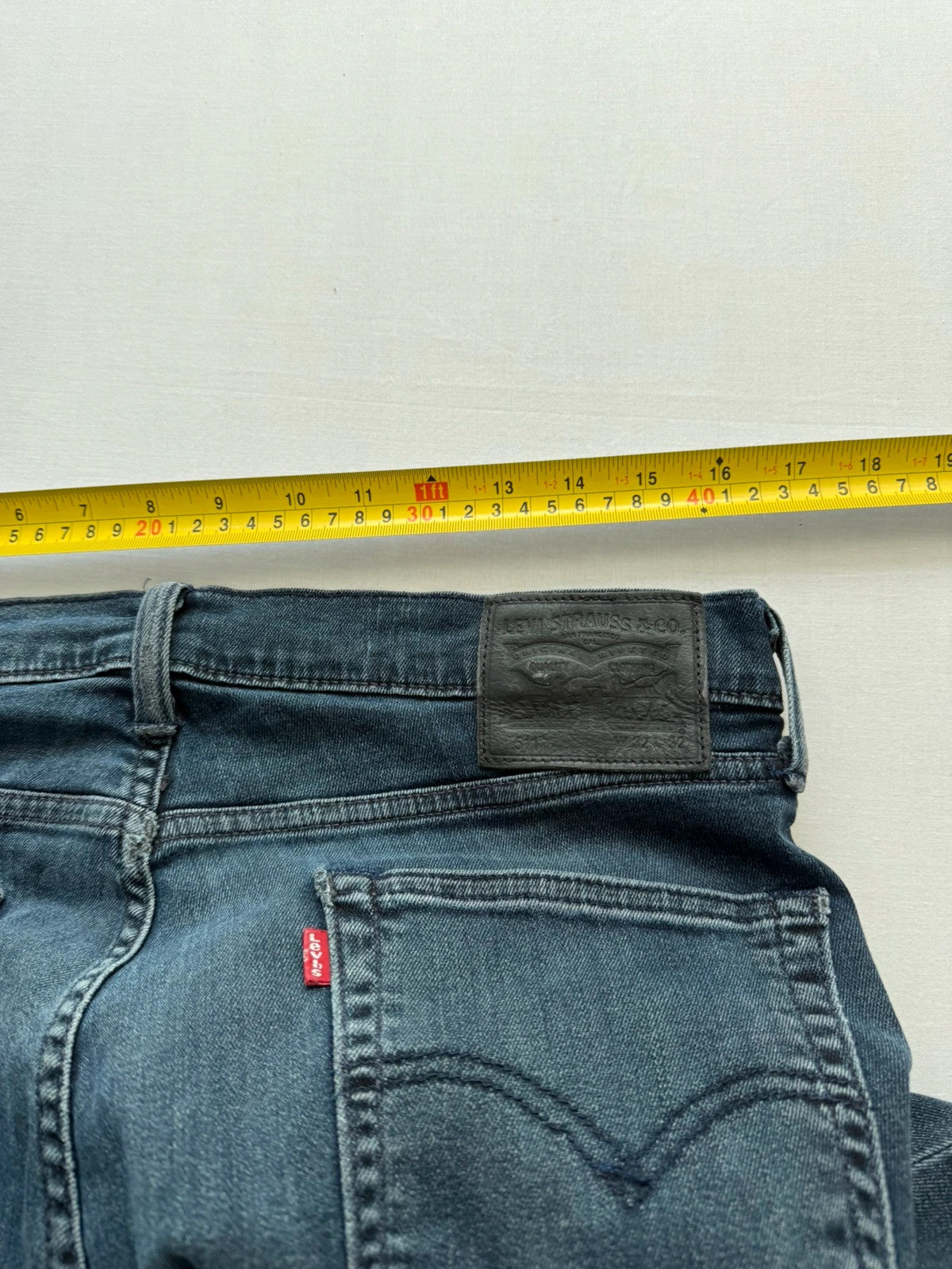 Levi's straight jeans dark indigo black wash with signature back arcuate stitching.