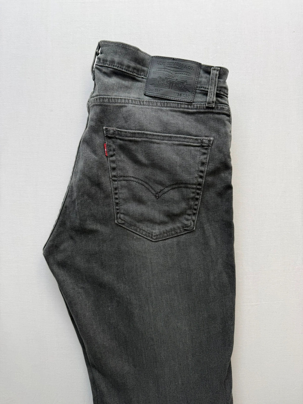 Levi's grey black slim fit jeans with classic five-pocket styling and back arcuate stitching.