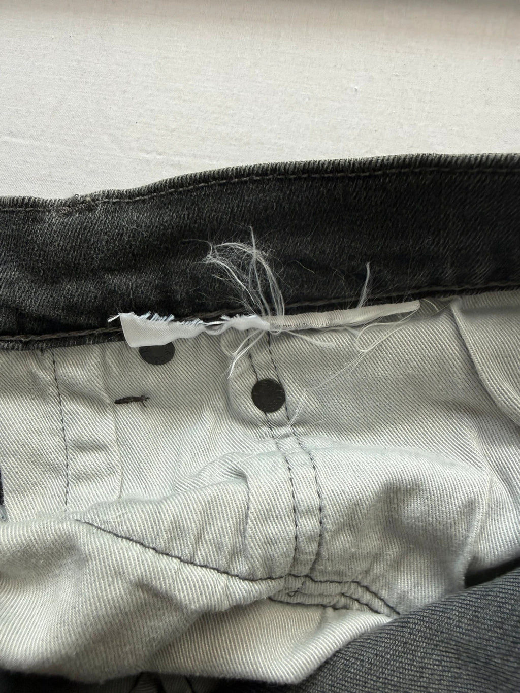 Levi's grey black slim fit jeans with classic five-pocket styling and back arcuate stitching.