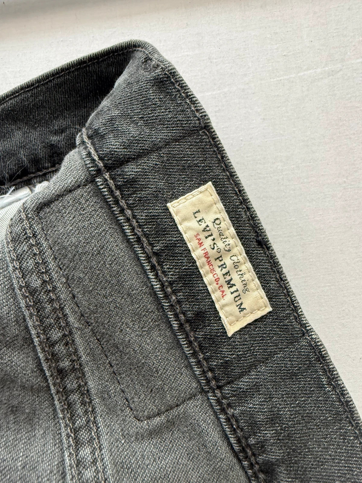 Levi's grey black slim fit jeans with classic five-pocket styling and back arcuate stitching.