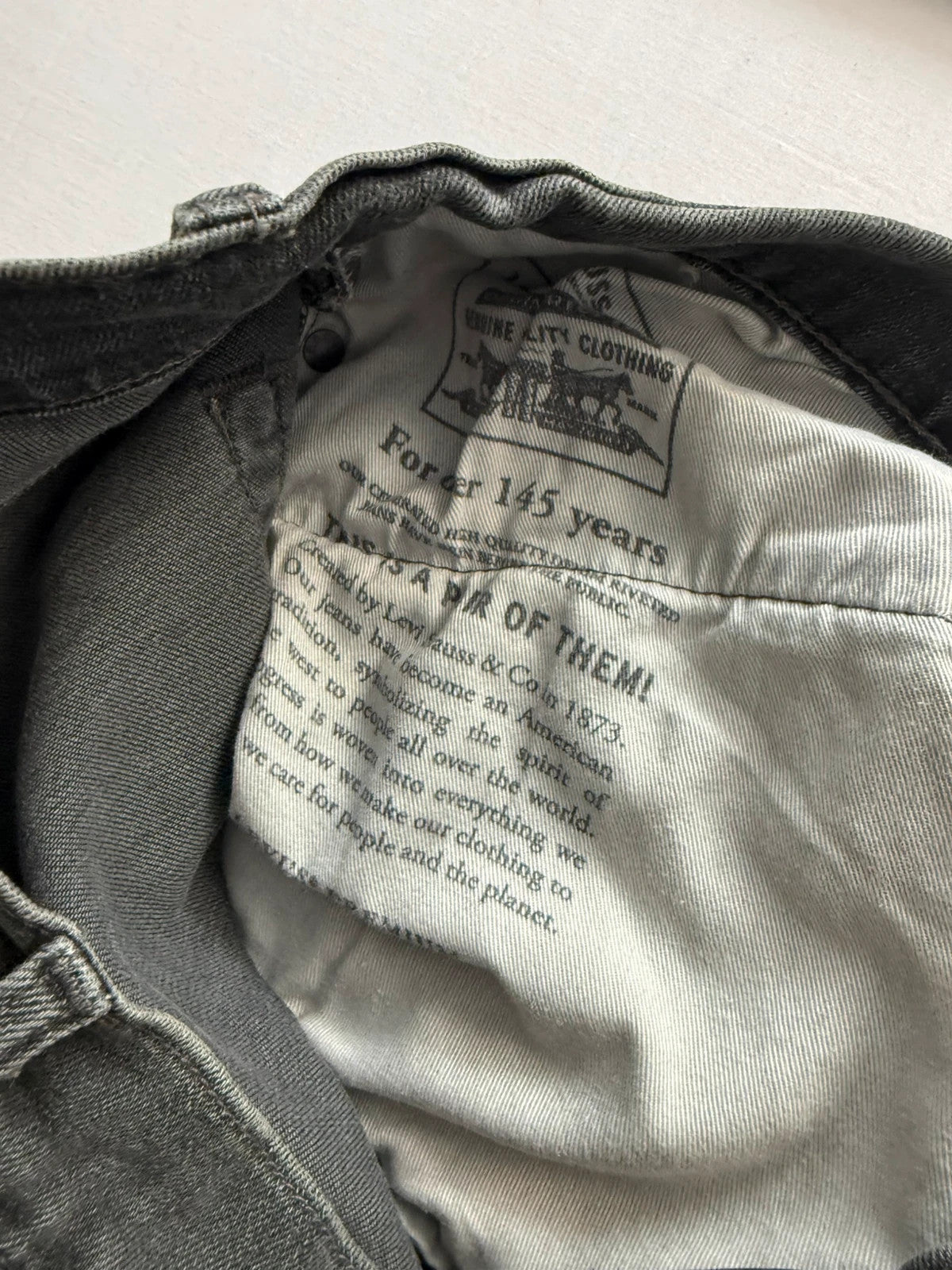 Levi's grey black slim fit jeans with classic five-pocket styling and back arcuate stitching.