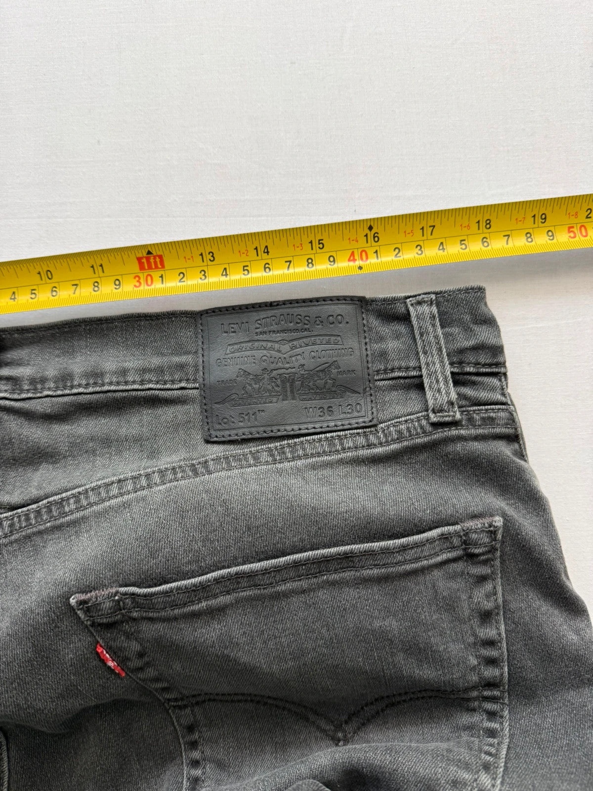 Levi's grey black slim fit jeans with classic five-pocket styling and back arcuate stitching.