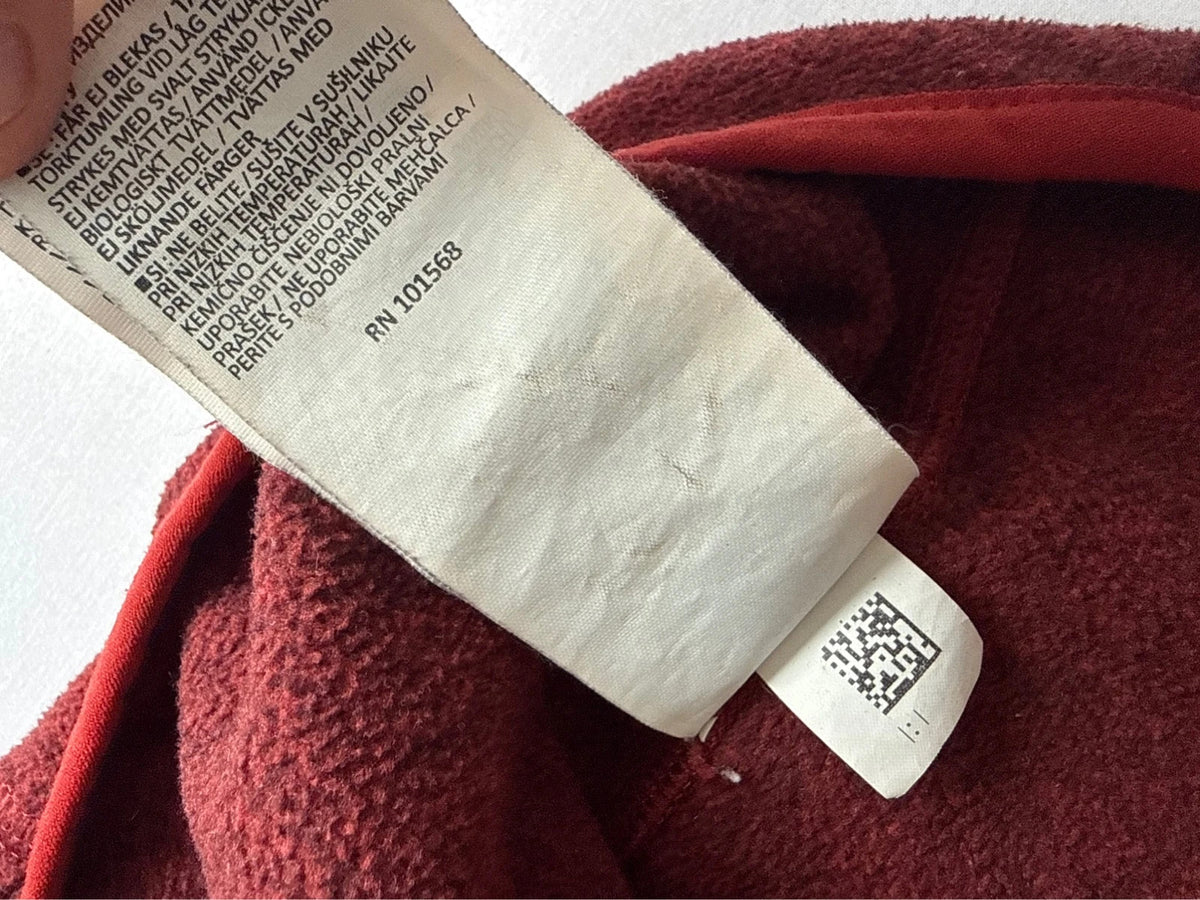 Berghaus burgundy quarter zip fleece with zip chest pocket and adjustable drawcord hem.