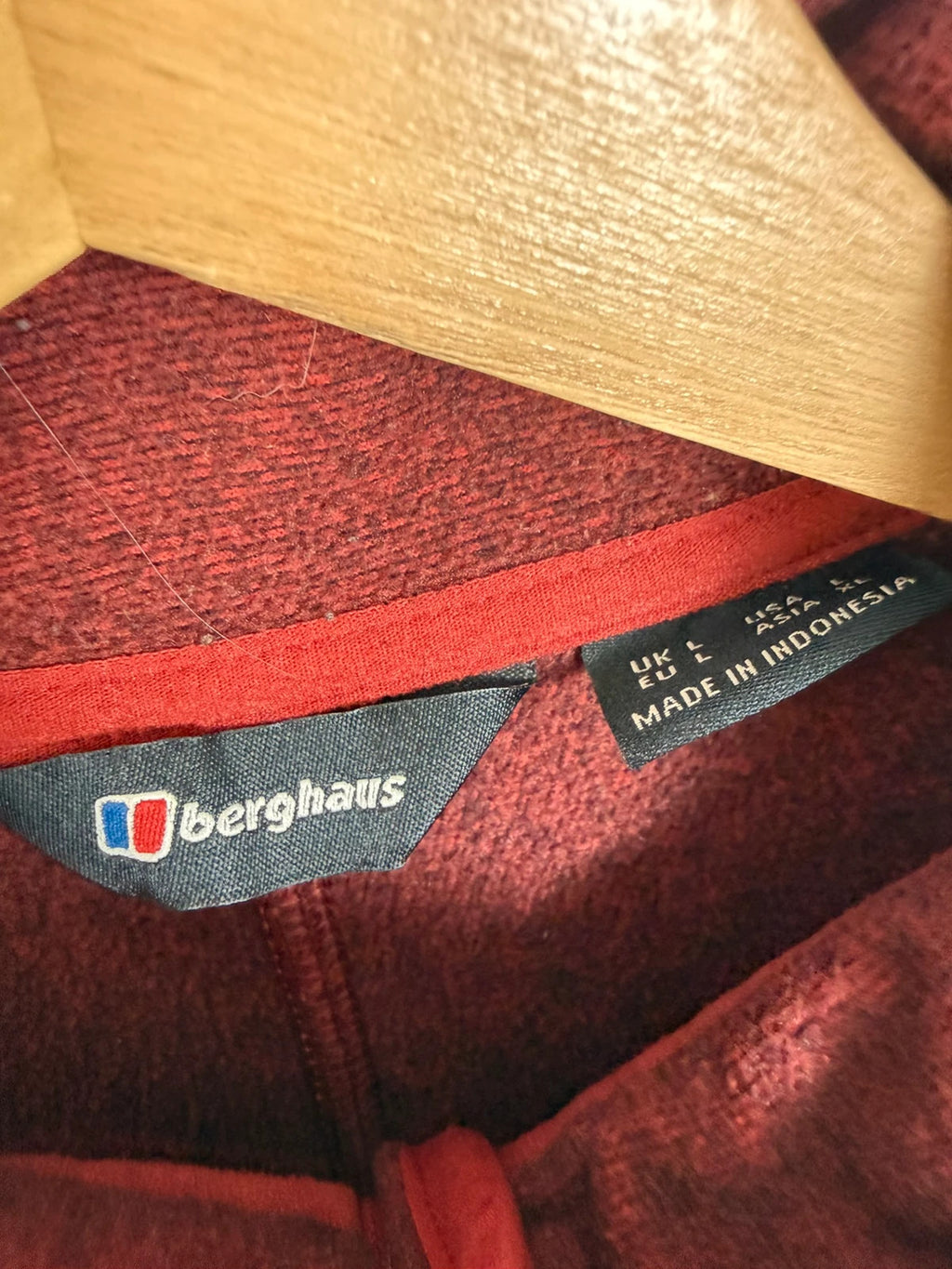 Berghaus burgundy quarter zip fleece with zip chest pocket and adjustable drawcord hem.