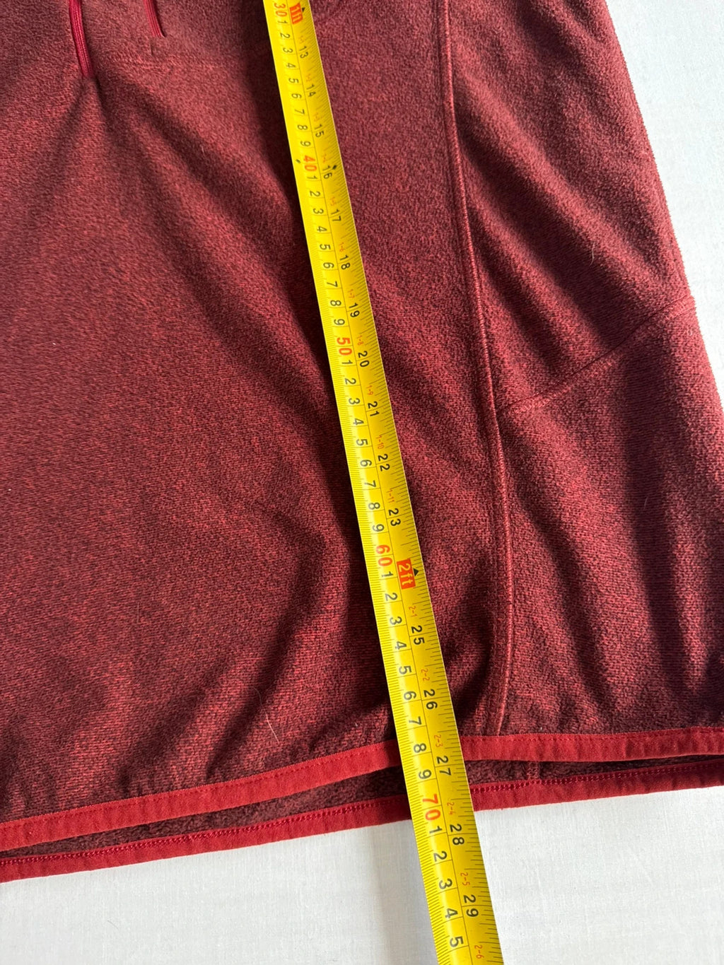 Berghaus burgundy quarter zip fleece with zip chest pocket and adjustable drawcord hem.