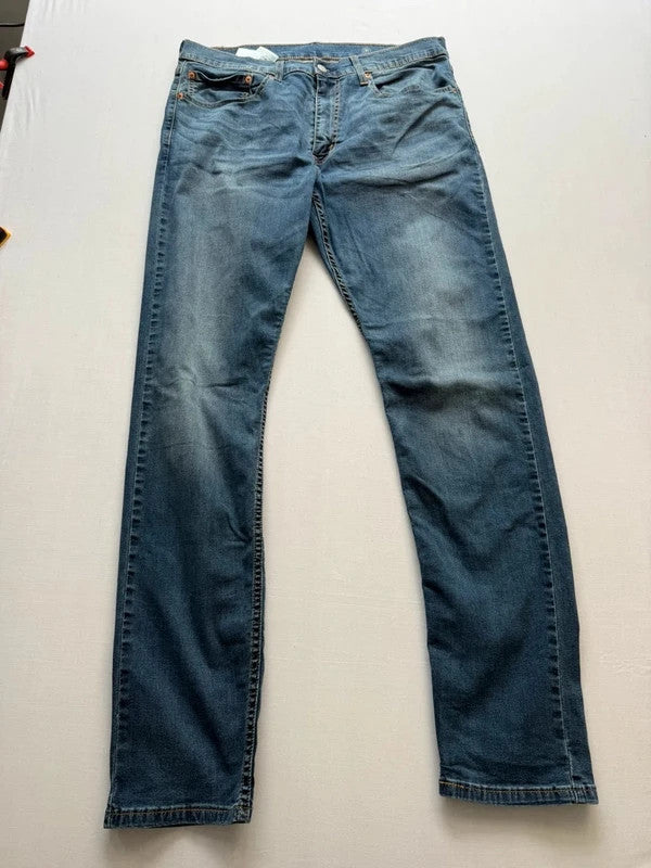 Levi's blue straight jeans with slim tapered fit and zip fly closure.