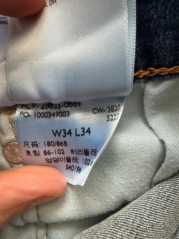 Levi's blue straight jeans with slim tapered fit and zip fly closure.