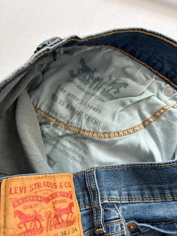 Levi's blue straight jeans with slim tapered fit and zip fly closure.
