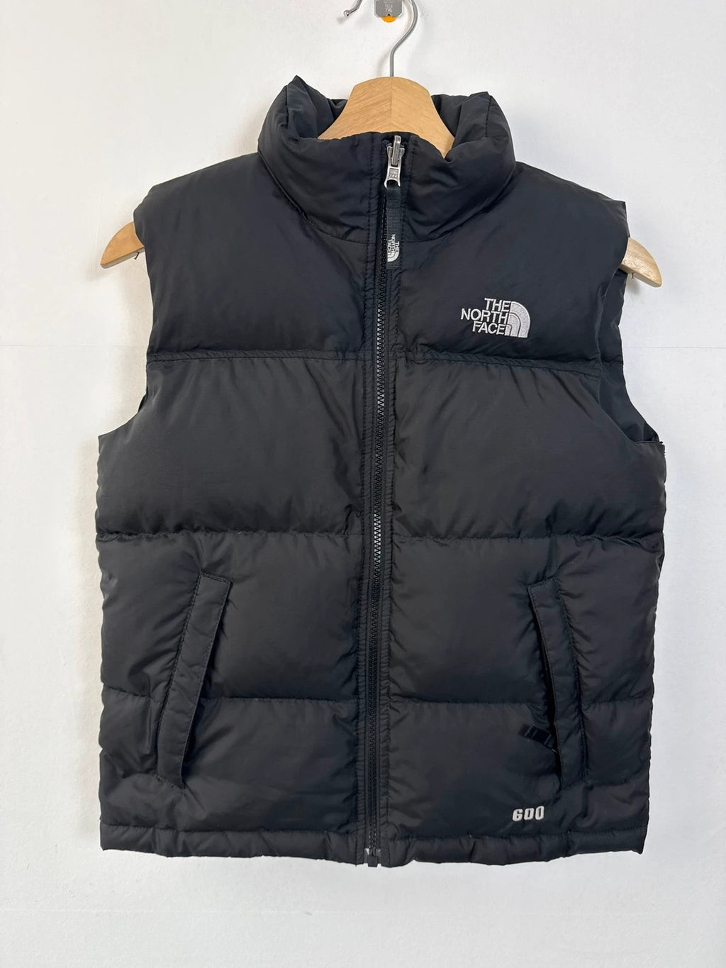 The North Face black puffer gilet with embroidered logo and stand-up collar.