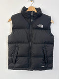 The North Face black puffer gilet with embroidered logo and stand-up collar.