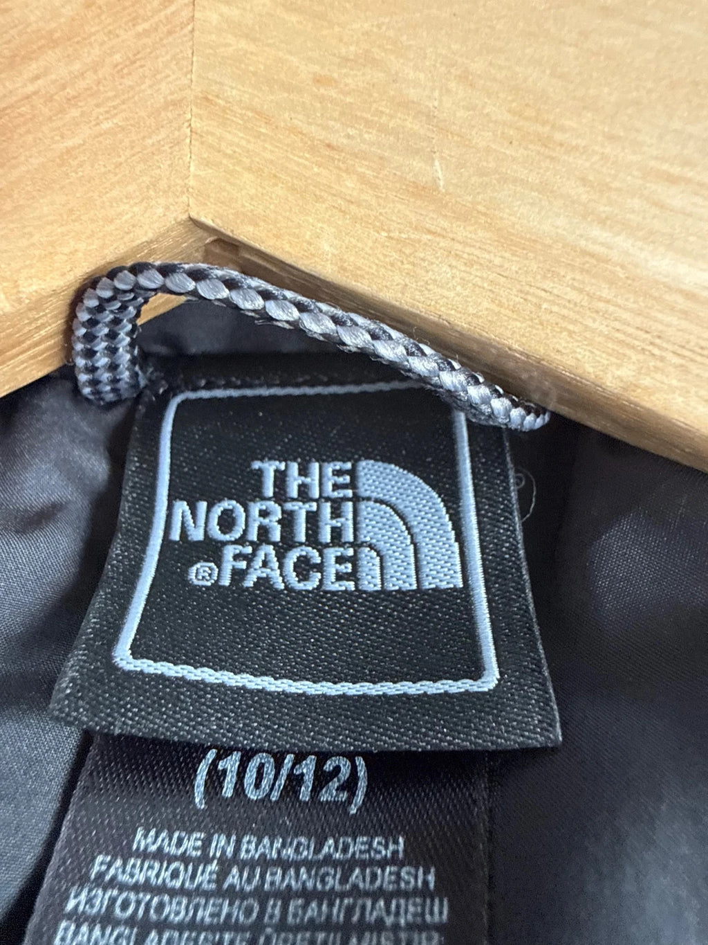 The North Face black puffer gilet with embroidered logo and stand-up collar.
