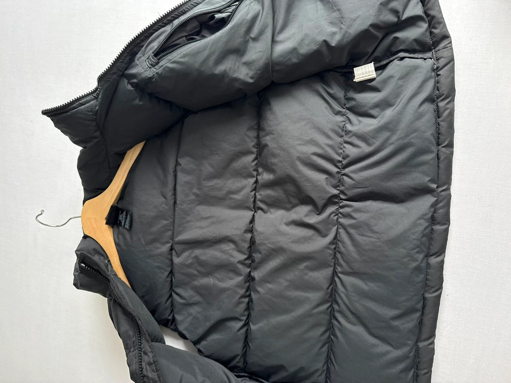 The North Face black puffer gilet with embroidered logo and stand-up collar.