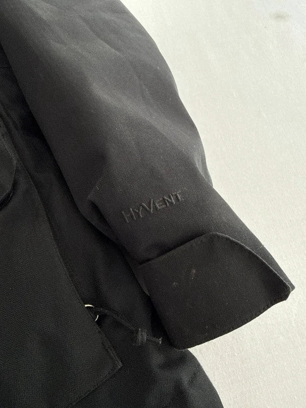The North Face black ski jacket with faux fleece-lined hood and multiple pockets.