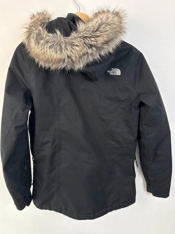 The North Face black ski jacket with faux fleece-lined hood and multiple pockets.