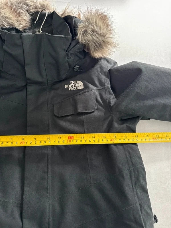 The North Face black ski jacket with faux fleece-lined hood and multiple pockets.