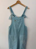 Lucy & Yak light blue dungarees with tie-up straps and large bib pocket, organic cotton.