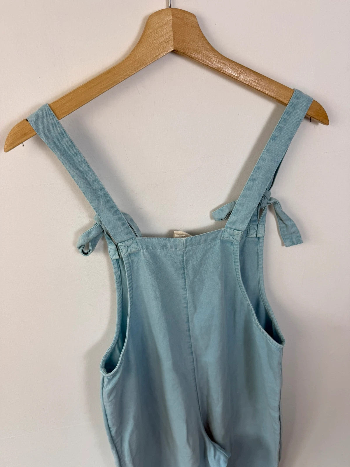 Lucy & Yak light blue dungarees with tie-up straps and large bib pocket, organic cotton.