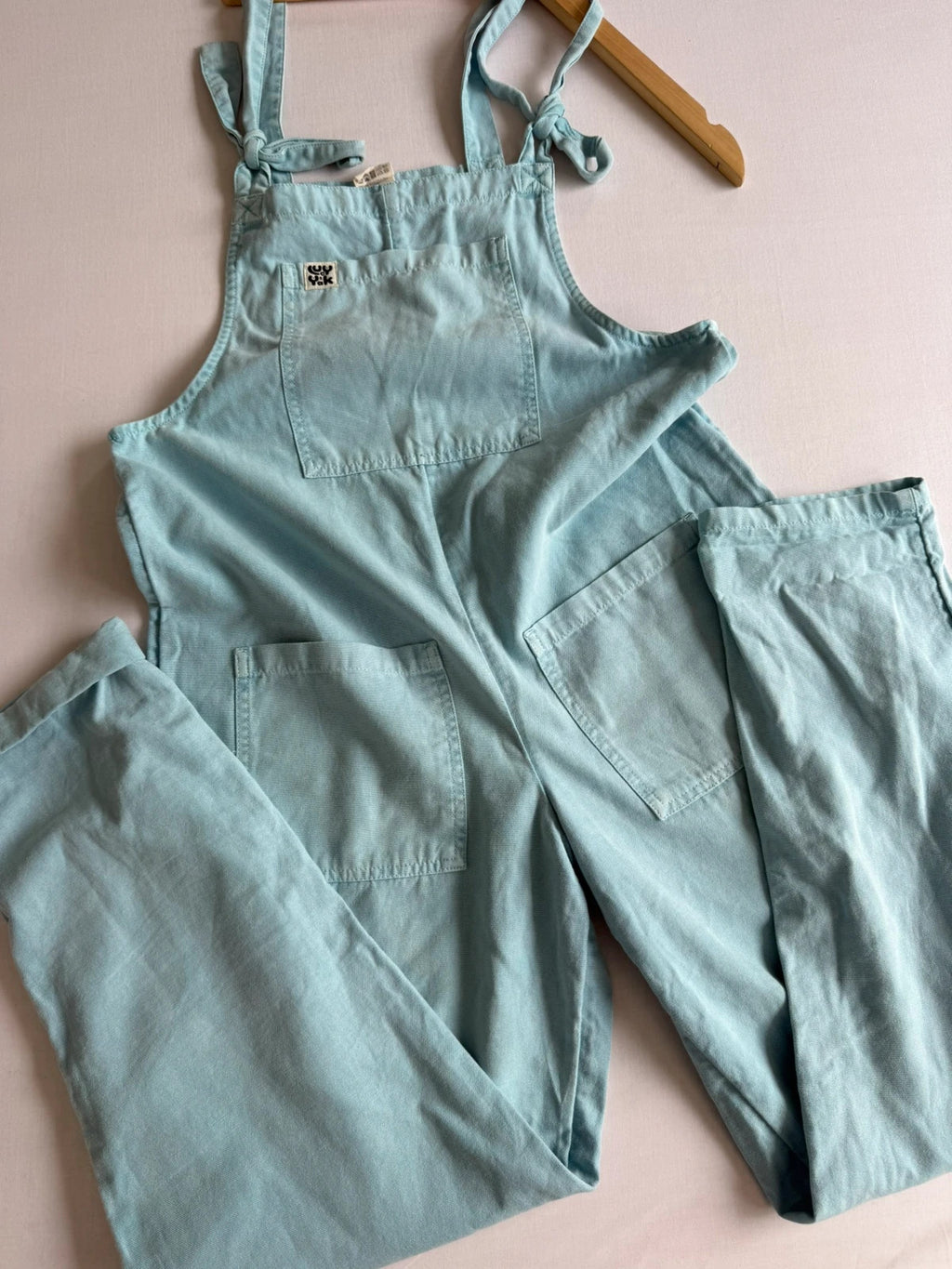 Lucy & Yak light blue dungarees with tie-up straps and large bib pocket, organic cotton.