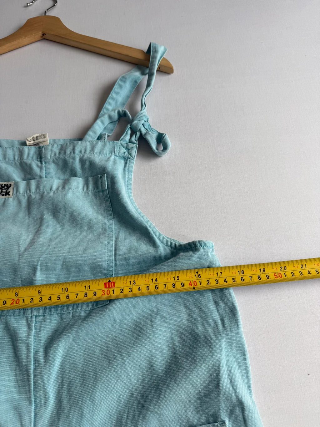 Lucy & Yak light blue dungarees with tie-up straps and large bib pocket, organic cotton.