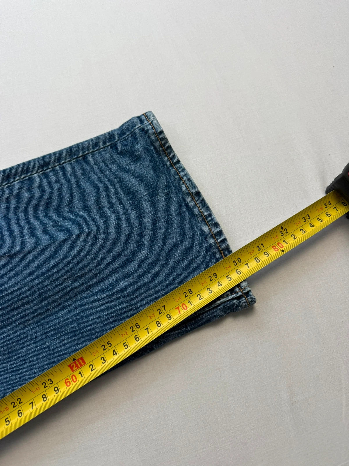Levi's blue straight jeans with leather back patch and red tab detail.