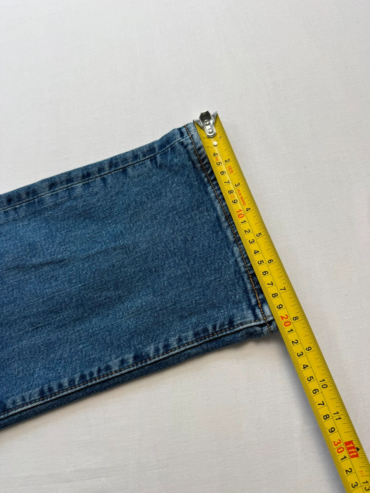 Levi's blue straight jeans with leather back patch and red tab detail.