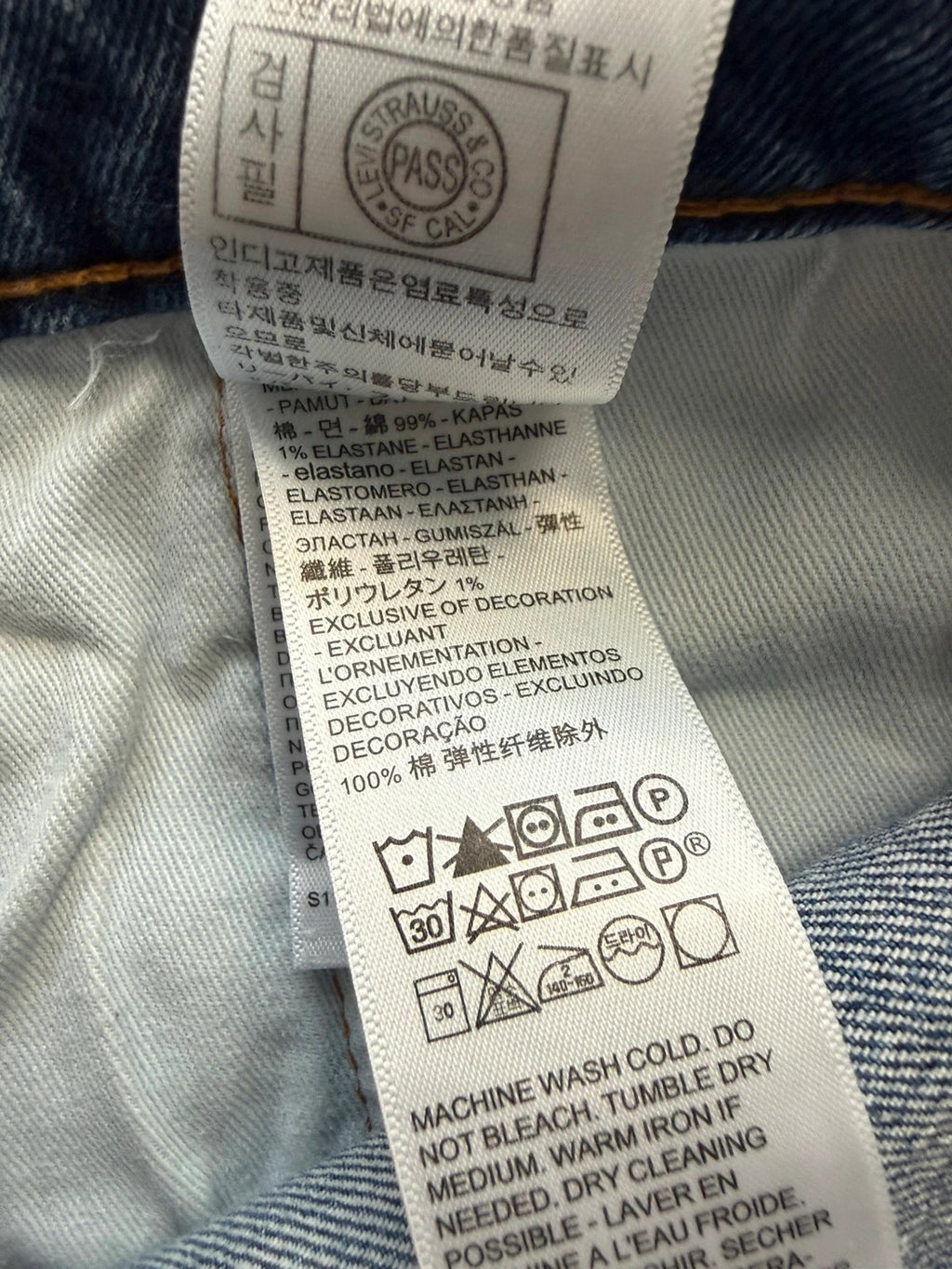 Levi's blue straight jeans with leather back patch and red tab detail.