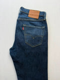 Levi's dark indigo slim fit jeans with leather back patch and red tab detail.