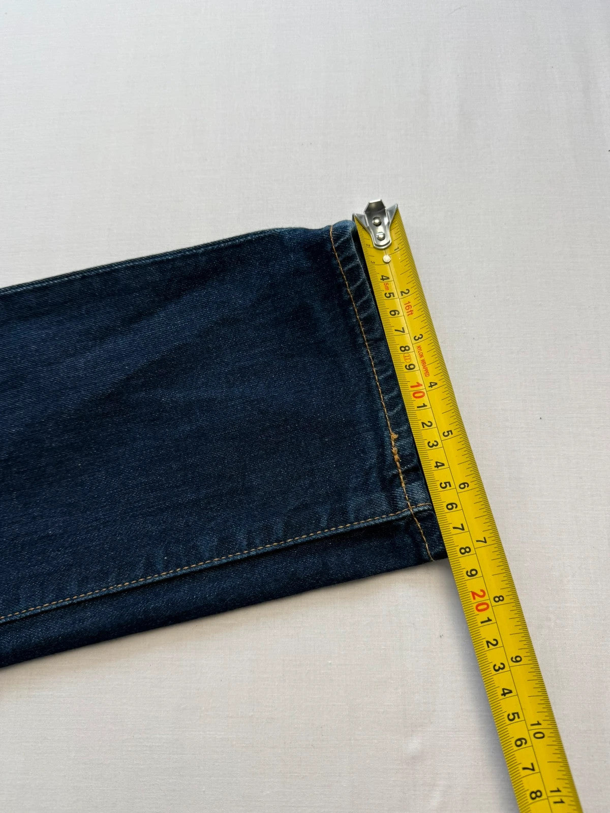 Levi's dark indigo slim fit jeans with leather back patch and red tab detail.
