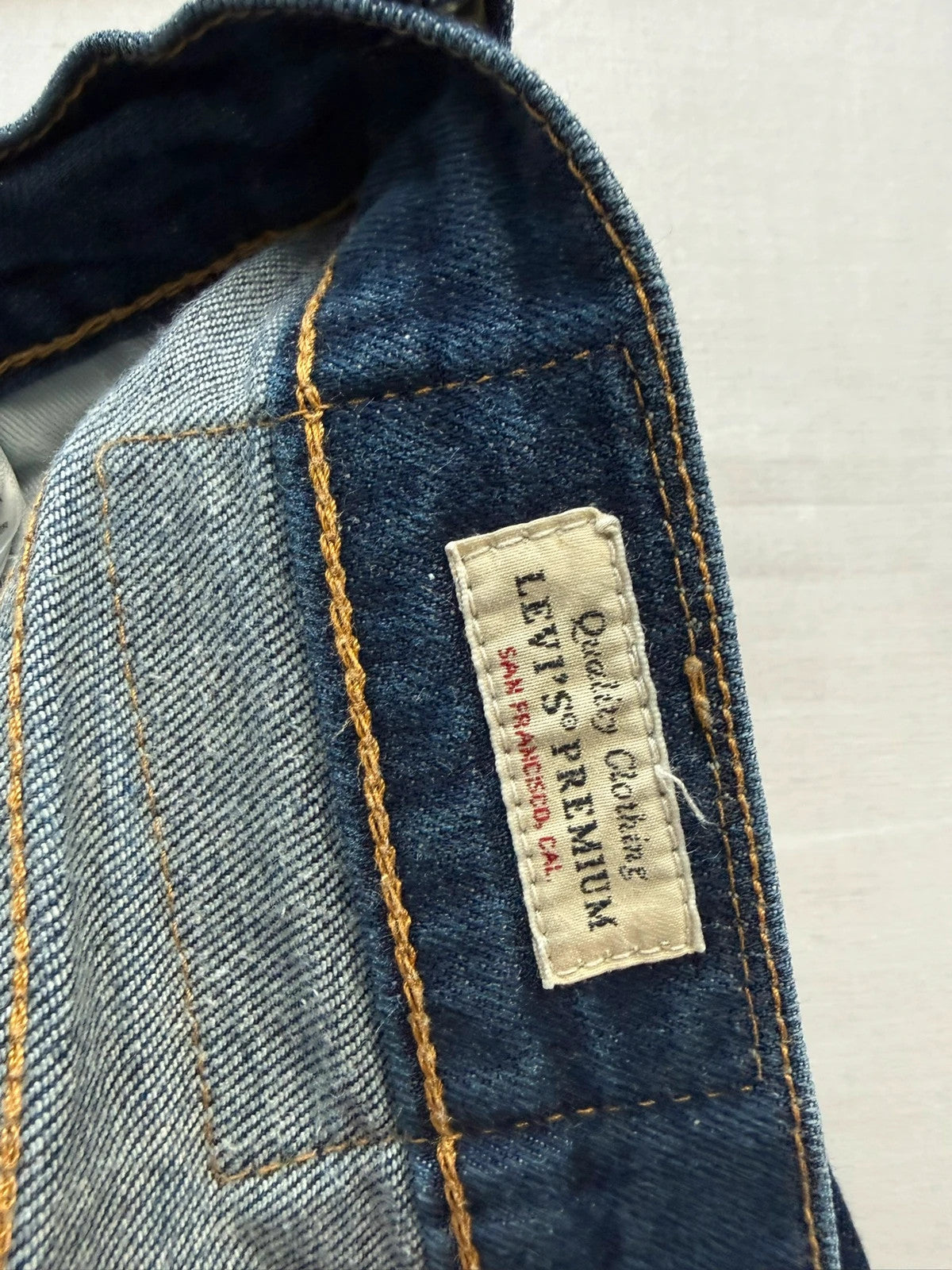 Levi's dark indigo slim fit jeans with leather back patch and red tab detail.