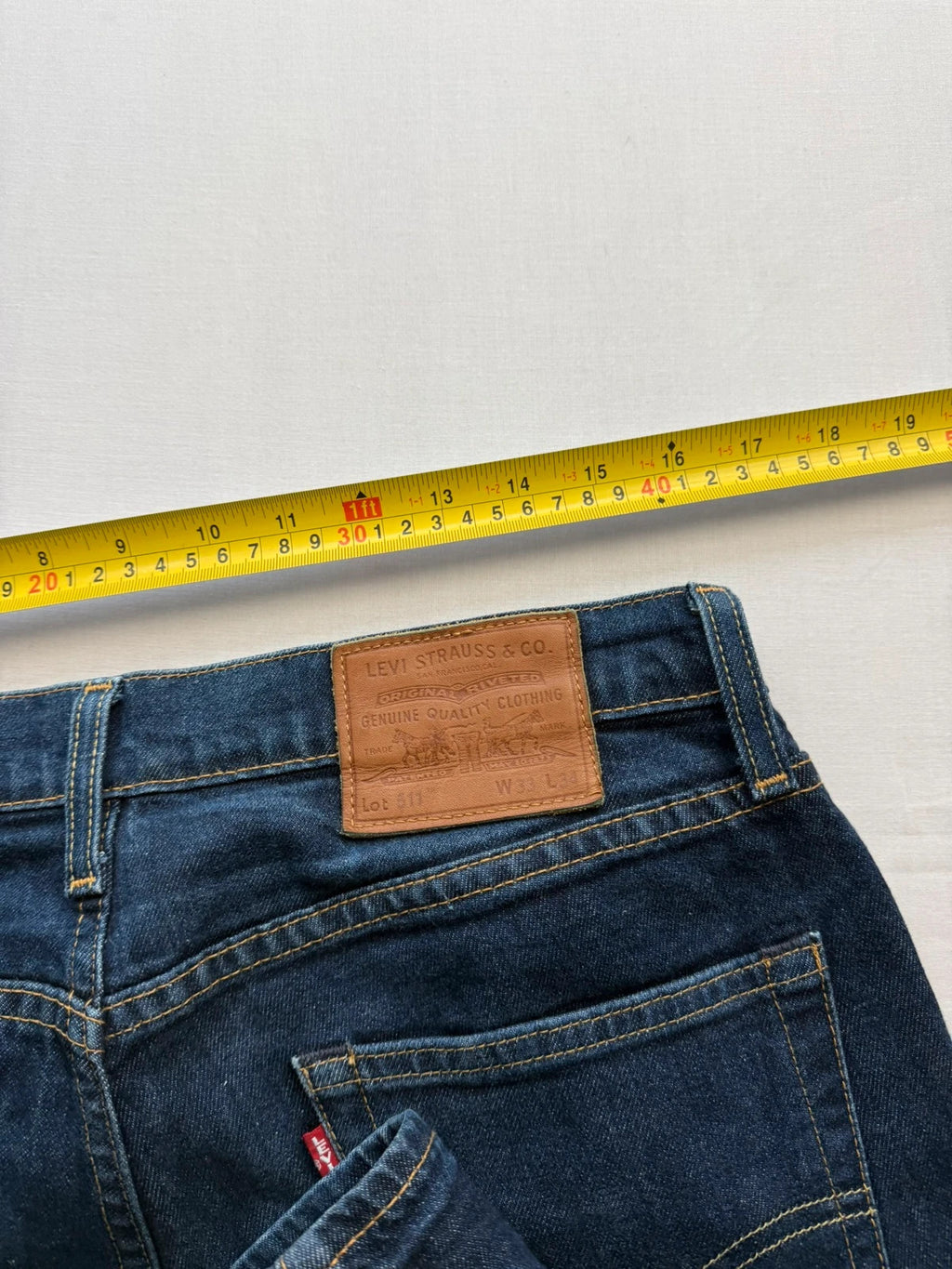 Levi's dark indigo slim fit jeans with leather back patch and red tab detail.