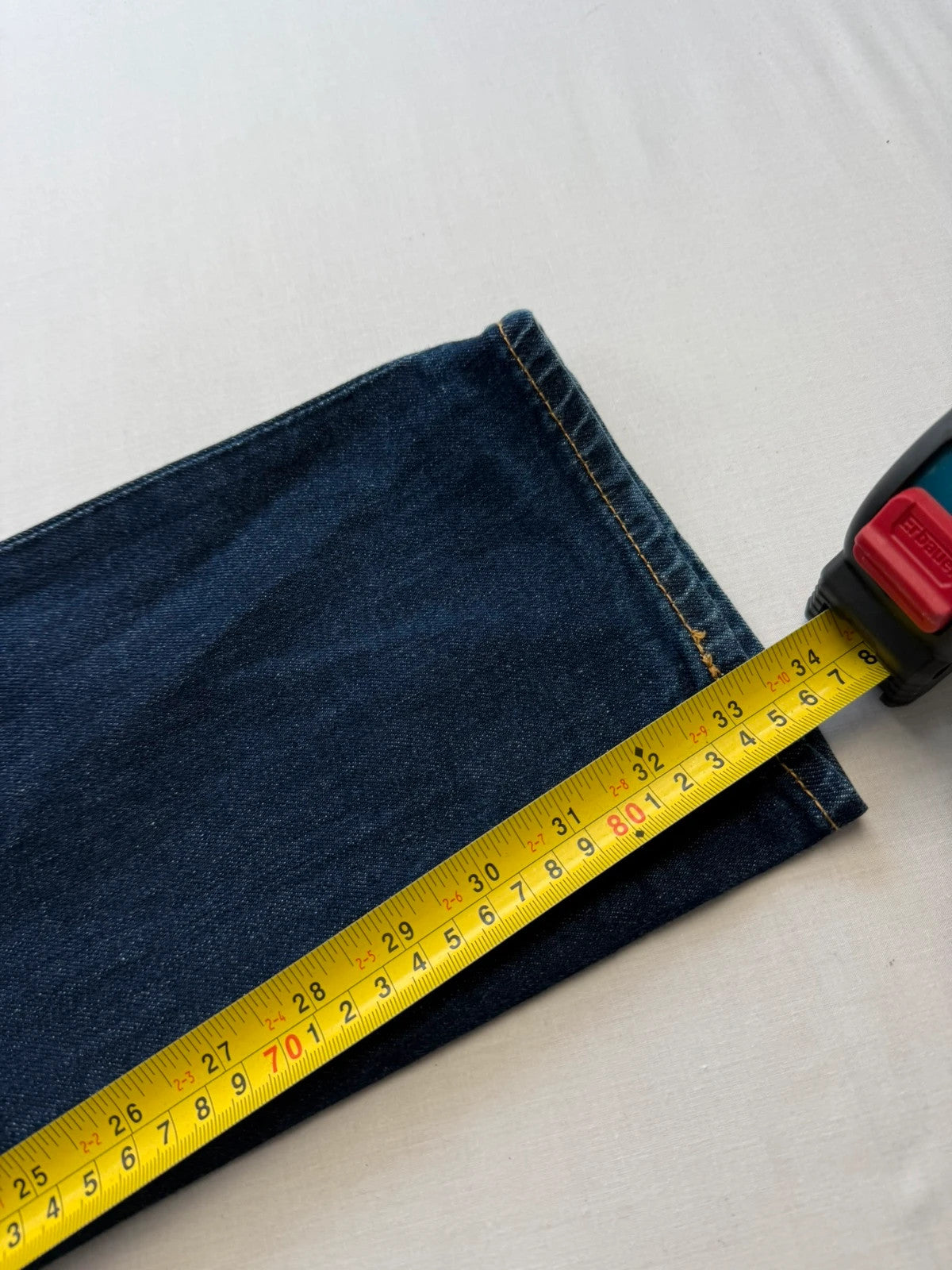Levi's dark indigo slim fit jeans with leather back patch and red tab detail.