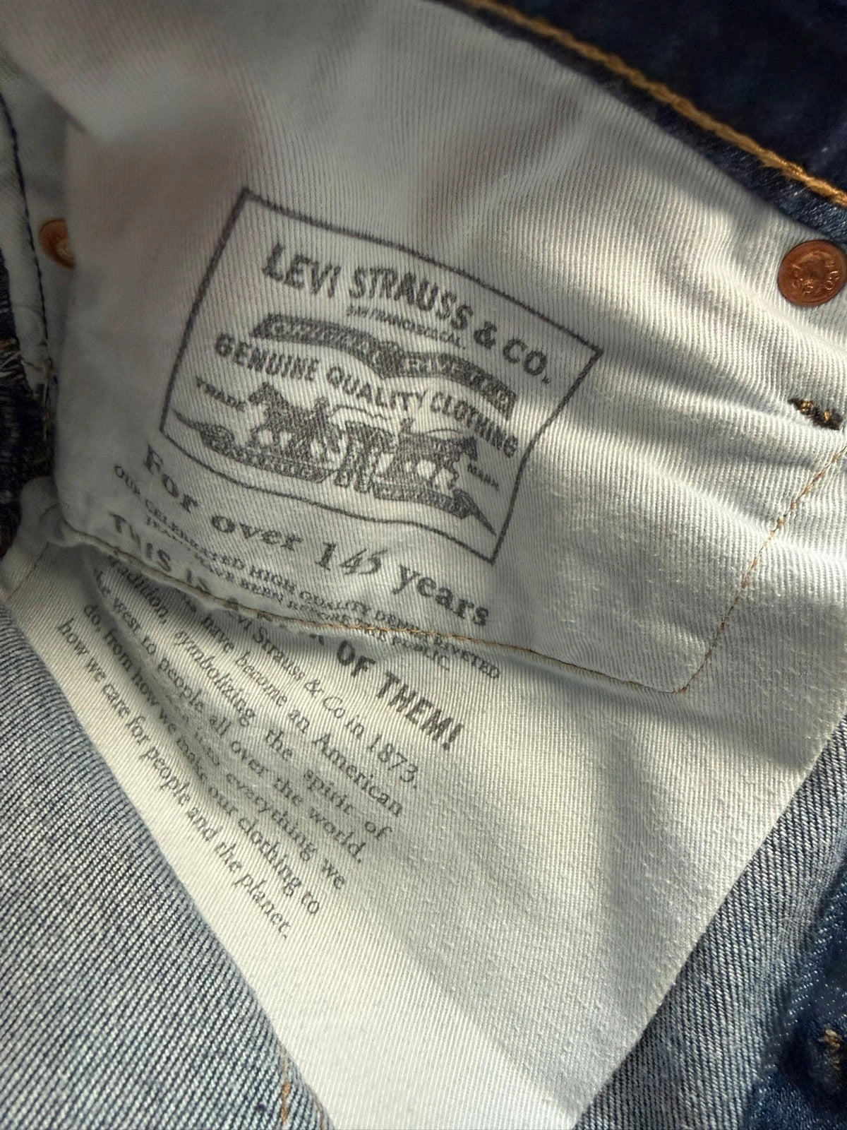 Levi's dark indigo slim fit jeans with leather back patch and red tab detail.