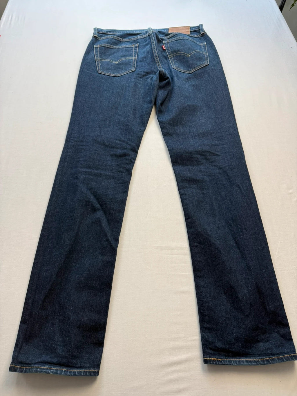 Levi's dark indigo slim fit jeans with leather back patch and red tab detail.